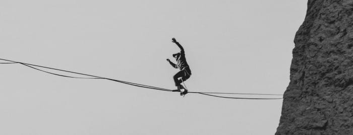 black bird on black wire during daytime